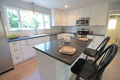 Inspiration for a large transitional l-shaped porcelain tile eat-in kitchen remodel in Philadelphia with a double-bowl sink, recessed-panel cabinets, white cabinets, quartzite countertops, white backsplash, subway tile backsplash, stainless steel appliances and an island
