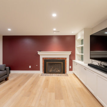 Contemporary Basement Lounge with Custom Built-ins and Accent Wall
