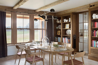 Mid-sized farmhouse light wood floor dining room photo in Denver with white walls
