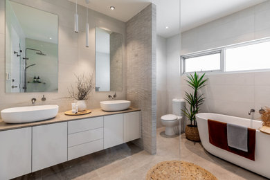 Photo of a mid-sized contemporary master bathroom in Adelaide with white cabinets, a freestanding tub, gray tile, ceramic tile, ceramic floors, engineered quartz benchtops, grey benchtops, a double vanity and a floating vanity.