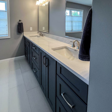 Primary Bathroom with Blue-Gray Vanity and Deep Blue Tiled Feature Wall