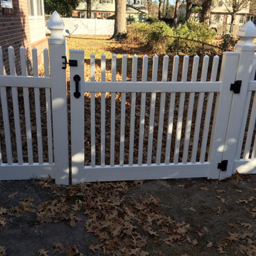 White vinyl picket fence with open spikes