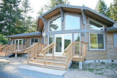 Example of a mid-sized trendy brown one-story wood gable roof design in Vancouver