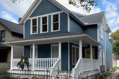 Large country blue two-story wood exterior home idea in Cleveland with a shingle roof
