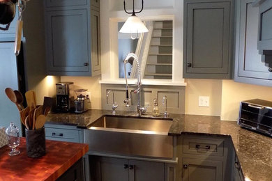 Eat-in kitchen - mid-sized farmhouse l-shaped light wood floor eat-in kitchen idea in Columbus with a farmhouse sink, shaker cabinets, gray cabinets, granite countertops, stainless steel appliances and an island