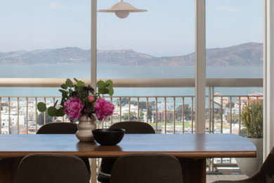Example of a mid-sized trendy light wood floor and brown floor great room design in San Francisco with white walls