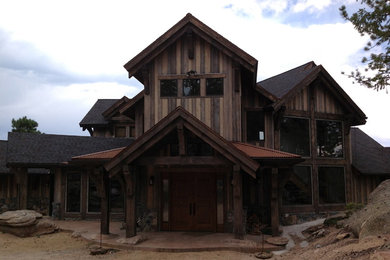 Large mountain style brown two-story exterior home photo in Denver
