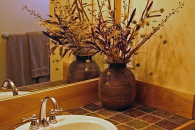 Bathroom - mid-sized transitional 3/4 light wood floor and brown floor bathroom idea in Other with shaker cabinets, medium tone wood cabinets, a two-piece toilet, beige walls, a drop-in sink and tile countertops