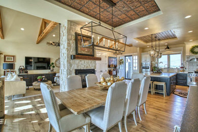 Kitchen/dining room combo - large french country medium tone wood floor, brown floor and tray ceiling kitchen/dining room combo idea in Other with a standard fireplace and beige walls