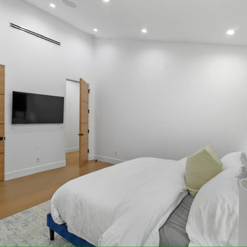 Bedroom Wall with Twin Oak Doors to Closet and Ensuite