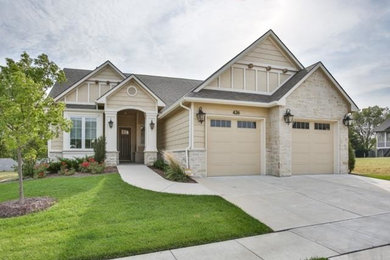 Example of a mid-sized transitional beige two-story mixed siding exterior home design in Wichita with a shingle roof