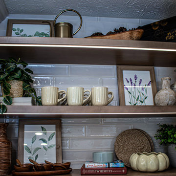Two Tone Kitchen with Floating Shelves and Island Seating and Updated Fireplace