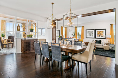 This is an example of a large transitional open plan dining in Chicago with white walls, dark hardwood floors and no fireplace.