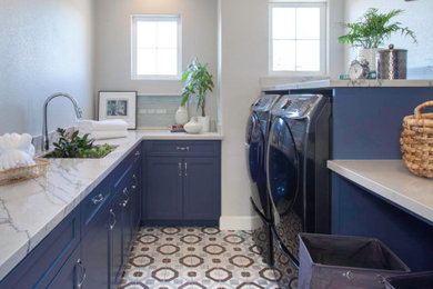 Example of a mid-sized minimalist galley ceramic tile and multicolored floor dedicated laundry room design in San Diego with flat-panel cabinets, blue cabinets and white walls