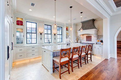 Large transitional u-shaped travertine floor and beige floor open concept kitchen photo in Miami with an undermount sink, white cabinets, granite countertops, gray backsplash, mosaic tile backsplash, stainless steel appliances, an island and recessed-panel cabinets