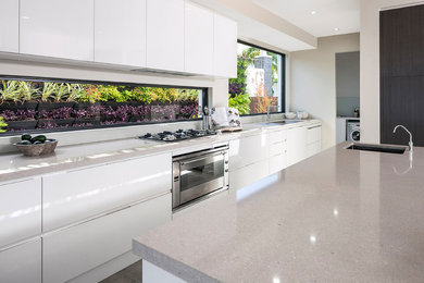 Design ideas for a small contemporary single-wall kitchen pantry in Sydney with a double-bowl sink, white cabinets, quartz benchtops, window splashback, stainless steel appliances, porcelain floors, a peninsula and grey floor.