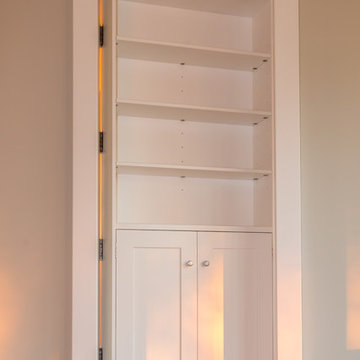 Secret bookcase door, TV unit and Monk's bench hallway storage