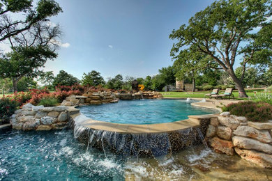 Inspiration for a mid-sized timeless backyard stone and custom-shaped lap pool fountain remodel in Austin
