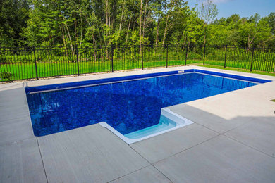 Pool landscaping - mid-sized contemporary backyard concrete and rectangular lap pool landscaping idea in Ottawa