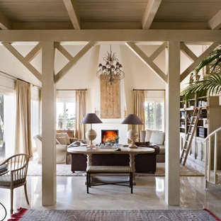 Design ideas for a medium sized mediterranean formal enclosed living room in Malaga with white walls, travertine flooring, a standard fireplace, a plastered fireplace surround and no tv.