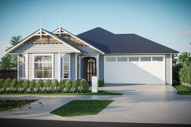 Design ideas for a mid-sized traditional one-storey grey house exterior in Auckland with wood siding, a gable roof, a metal roof, a blue roof and clapboard siding.
