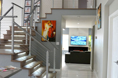 Inspiration for a mid-sized contemporary wood u-shaped staircase in San Francisco with wood risers and metal railing.