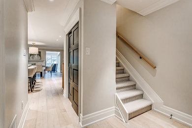 Inspiration for a transitional hallway in Toronto with beige walls, light hardwood floors and beige floor.