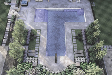 Inspiration for a large timeless backyard stone and custom-shaped pool landscaping remodel in Cleveland