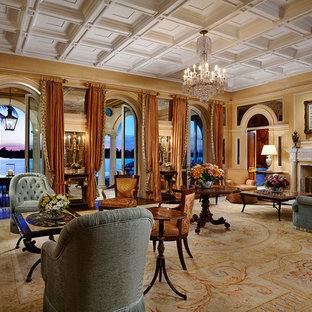 Foto de salón para visitas cerrado, mediterráneo, extra grande, sin televisor, con paredes multicolor, suelo de madera oscura, chimenea tradicional, suelo marrón y marco de chimenea de yeso