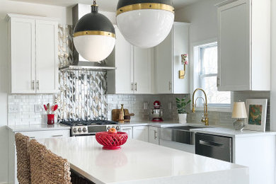 Eat-in kitchen - mid-sized eclectic u-shaped dark wood floor eat-in kitchen idea in Boston with a farmhouse sink, shaker cabinets, white cabinets, glass tile backsplash, stainless steel appliances, an island and white countertops
