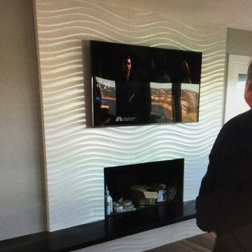 Modern low profile install on tiled fireplace.