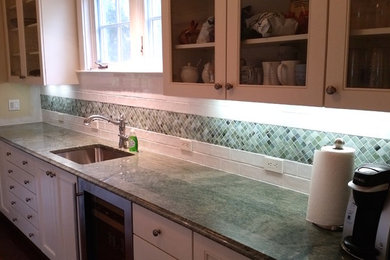 Kitchen photo in Baltimore with glass-front cabinets