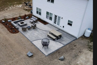 Patio - mid-sized modern backyard concrete paver patio idea in Raleigh with a fireplace