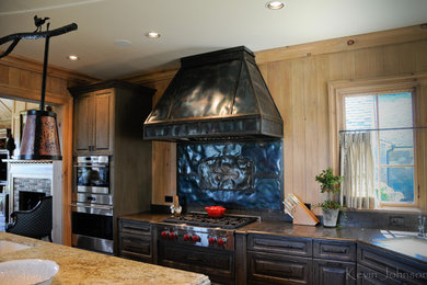 Large elegant u-shaped dark wood floor open concept kitchen photo in Other with an undermount sink, raised-panel cabinets, distressed cabinets, granite countertops, black backsplash, metal backsplash, stainless steel appliances and an island