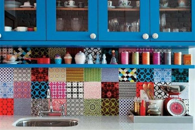 Kitchen - mid-sized eclectic l-shaped kitchen idea in Milwaukee with an undermount sink, shaker cabinets, blue cabinets, solid surface countertops, multicolored backsplash, ceramic backsplash and a peninsula