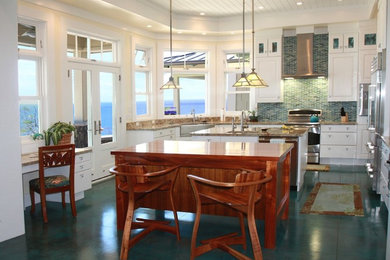 Inspiration for a large craftsman u-shaped concrete floor and turquoise floor kitchen remodel in Hawaii with an undermount sink, shaker cabinets, white cabinets, granite countertops, multicolored backsplash, glass tile backsplash, stainless steel appliances, two islands and beige countertops