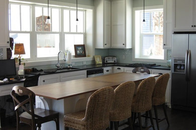 Kitchen - mid-sized coastal l-shaped dark wood floor kitchen idea in Miami with an undermount sink, shaker cabinets, white cabinets, blue backsplash, porcelain backsplash, stainless steel appliances and an island