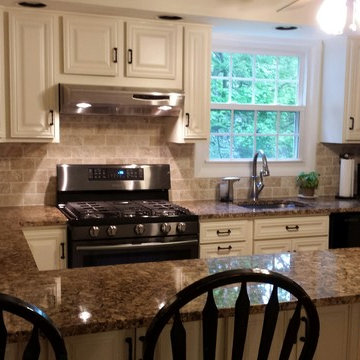 cabinet refacing--antique white with granite and travertine backsplash