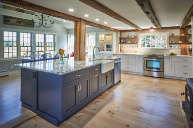 Eat-in kitchen - cottage light wood floor, brown floor and exposed beam eat-in kitchen idea in Boston with a farmhouse sink, shaker cabinets, white cabinets, quartz countertops, white backsplash, subway tile backsplash, stainless steel appliances, an island and blue countertops