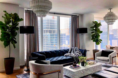 Large trendy formal and open concept light wood floor and brown floor living room photo in New York with white walls, no fireplace and a wall-mounted tv