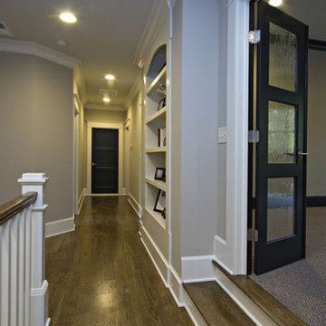 Wood-floor hallway with stairs to game room