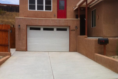 Example of a large southwest brown two-story stucco exterior home design in San Diego with a shingle roof