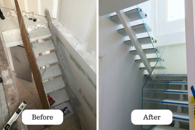 Example of a small minimalist u-shaped glass railing staircase design in New York