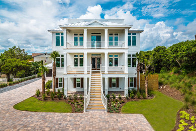 Beach style three-story house exterior photo in Jacksonville with a metal roof