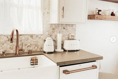 Eat-in kitchen - mid-sized transitional ceramic tile and beige floor eat-in kitchen idea in San Francisco with a farmhouse sink, shaker cabinets, white cabinets, quartz countertops, multicolored backsplash, mosaic tile backsplash, white appliances and gray countertops