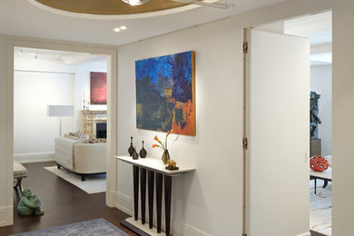 This is an example of a mid-sized transitional foyer in New York with white walls, medium hardwood floors, a single front door and a white front door.