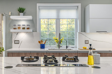 Mid-sized trendy u-shaped porcelain tile and beige floor open concept kitchen photo in DC Metro with a single-bowl sink, flat-panel cabinets, white cabinets, quartz countertops, white backsplash, quartz backsplash, paneled appliances, an island and white countertops