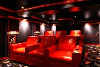 Home theater - mid-sized enclosed carpeted home theater idea in Detroit with black walls and a projector screen