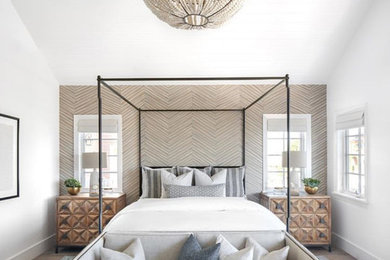 Example of a transitional medium tone wood floor and brown floor bedroom design in Orange County with white walls