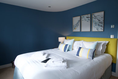 Design ideas for a medium sized beach style guest bedroom in Cornwall with blue walls, carpet and beige floors.